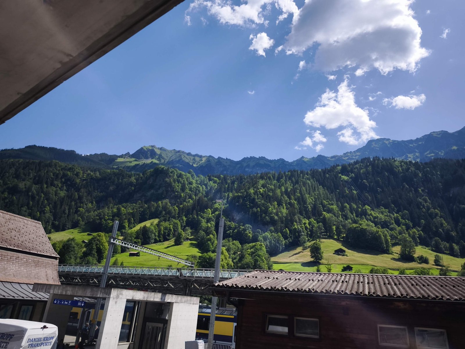 Grindelwald village nestled in green alpine slopes beneath the Swiss Alps