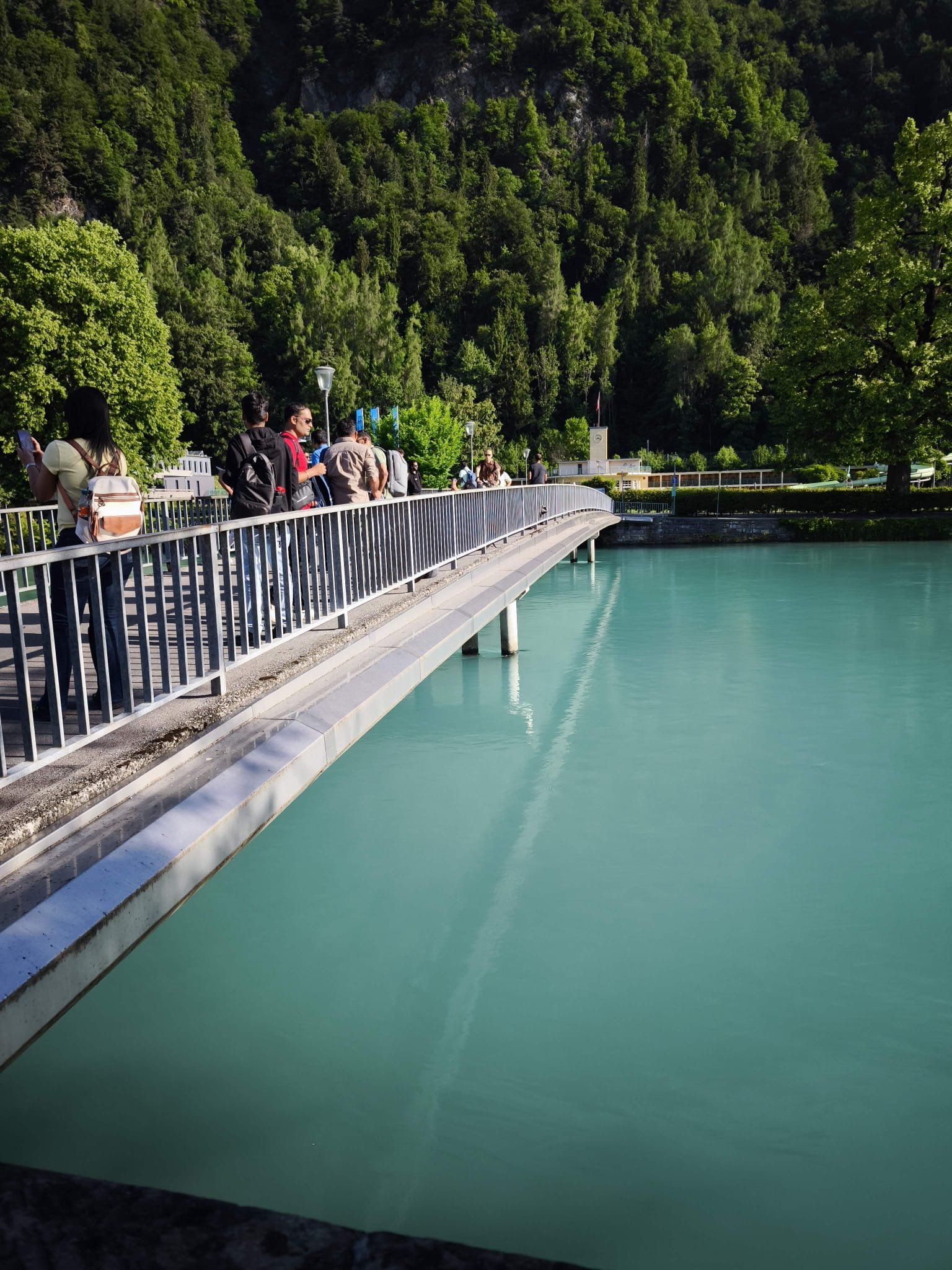 Turquoise Aare river and mountain backdrop in Interlaken town centre, Switzerland