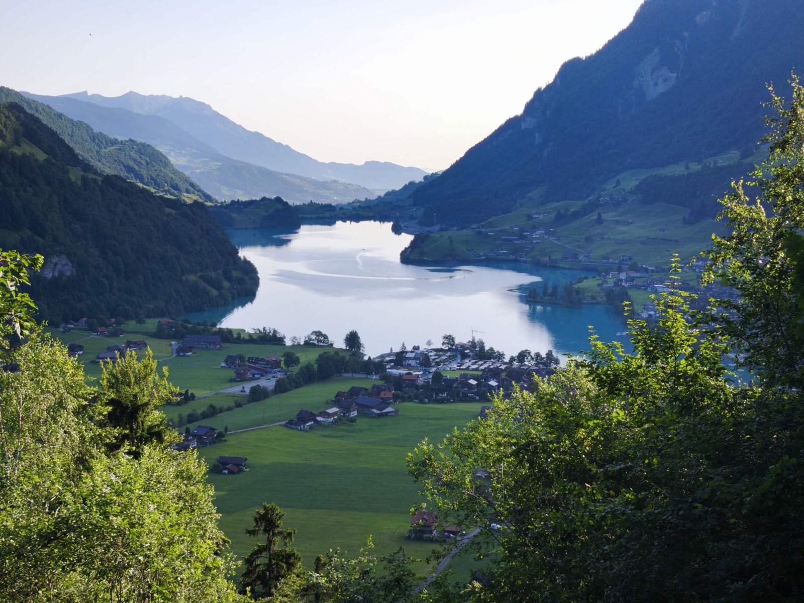 Scenic Swiss alpine lake valley with traditional villages on the drive to Interlaken from Zürich