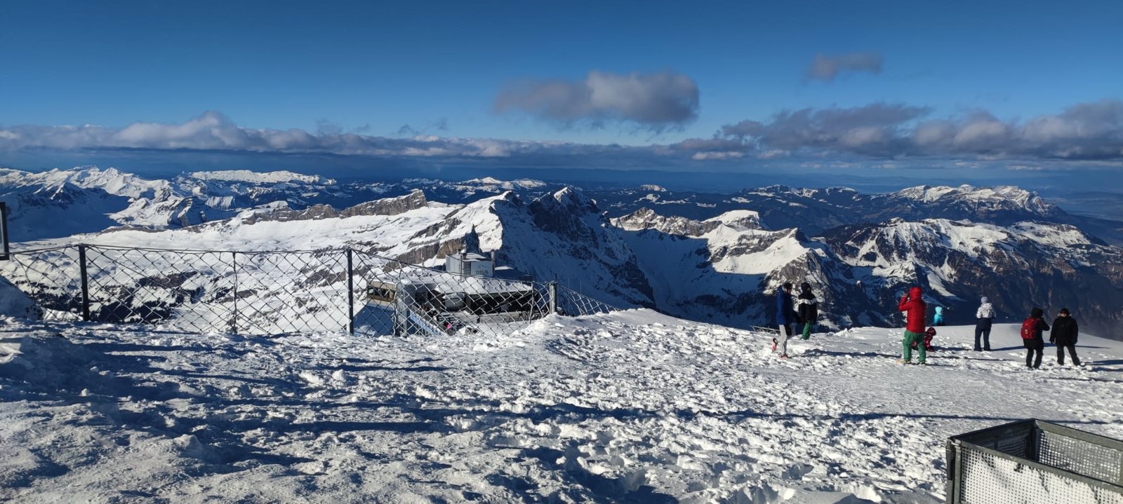 Mount Pilatus summit observation area with panoramic snow-covered Swiss Alps on a day trip