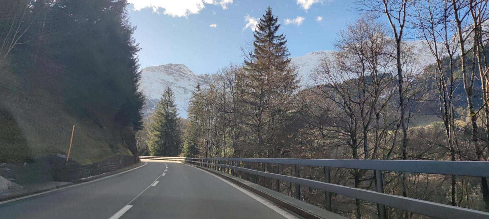 Scenic alpine road with snow-capped Swiss mountain peaks on the drive to Lucerne from Zürich